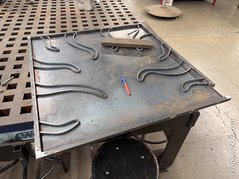 The tentacled frame is on the sheet, and a marker is resting on it, having been used to trace the edges of the tentacles